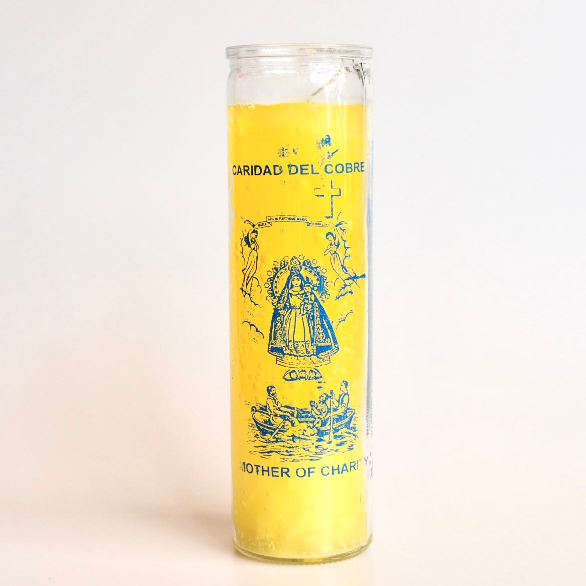 'Mother of Charity Cobre' Vela 7 Day Prayer Candle by Santa Sabina glass screen-printed pillar holder in yellow wax. UK