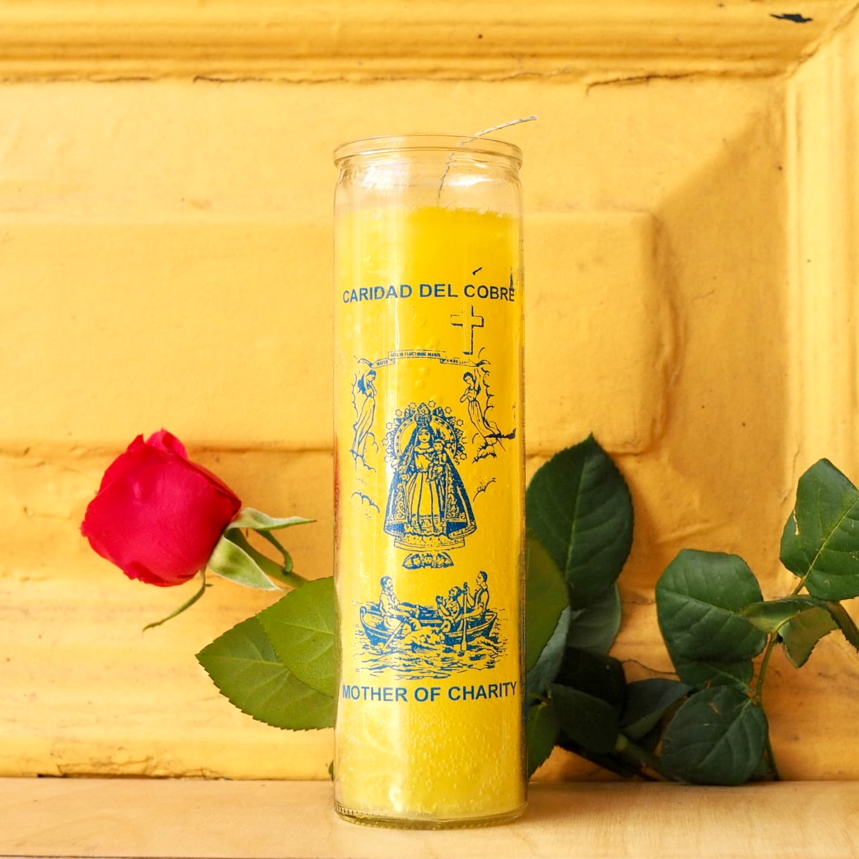 'Mother of Charity Cobre' Vela 7 Day Prayer Candle by Santa Sabina glass screen-printed pillar holder in yellow wax. UK